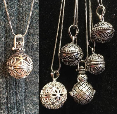 silver plated shaped balls on chains with essential oils inside. 
